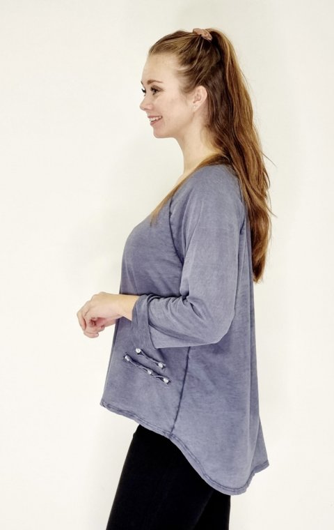 Varm r bl bluse i 100% bomuld, med rib V udskring, lnger bagp og pynt i siden. Str. One Size.